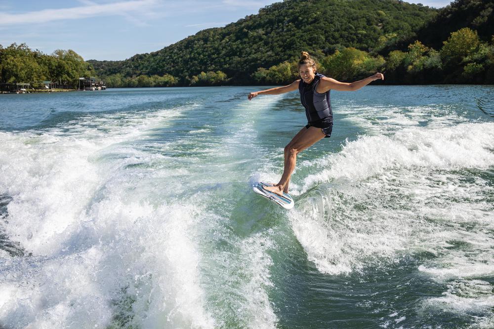 Woman wake surfing on Lake Austin